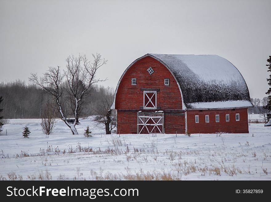 Old red barn surrounded by snow. Old red barn surrounded by snow