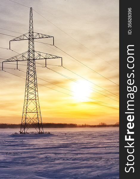 One power grid surrounded by snow at sunset. One power grid surrounded by snow at sunset