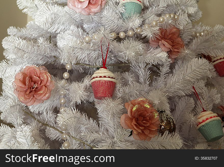 Christmas white tree, with a flower and cupcake. Christmas white tree, with a flower and cupcake