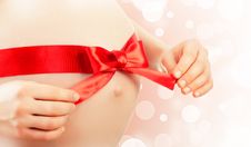 Belly Of Pregnant Woman With Red Ribbon And Bow Stock Photos