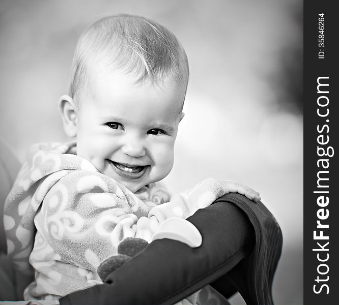 A happy baby laughing and smiling monochrome