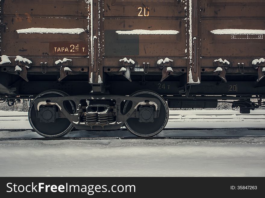 Old vintage train wagon and running gear with driving wheels. Wintertime background. Old vintage train wagon and running gear with driving wheels. Wintertime background.