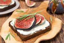Bread With Goat Cheese, Figs, Honey And Rosemary On Wooden Board Stock Images