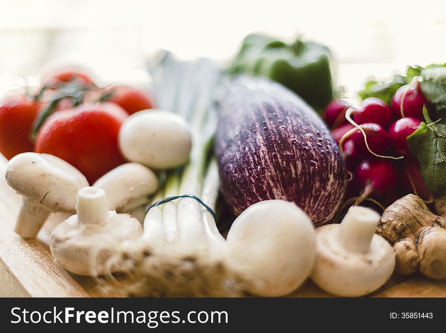 Homegrown organic produce on wooden cutting board outdoors. Homegrown organic produce on wooden cutting board outdoors