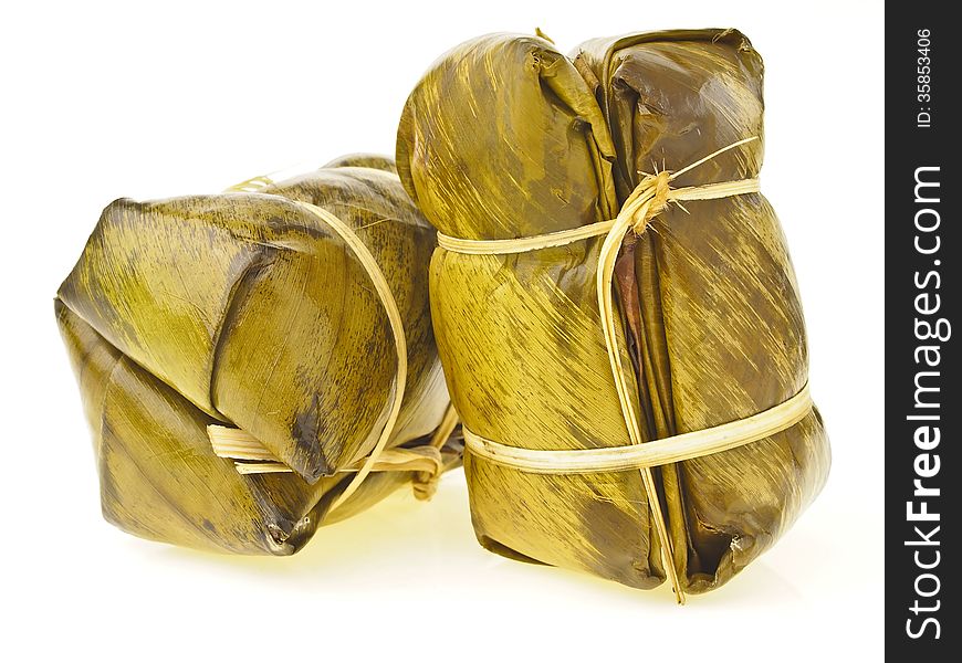 Pile of two Khao Tom Mat pack isolated on white background. Khao Tom Mat is thai dessert. it make from sticky-rice sugar banana and wrap in banana leaf. final is cooked with steam. Pile of two Khao Tom Mat pack isolated on white background. Khao Tom Mat is thai dessert. it make from sticky-rice sugar banana and wrap in banana leaf. final is cooked with steam