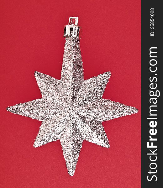 Ornament eight pointed sliver star on red background. Ornament eight pointed sliver star on red background