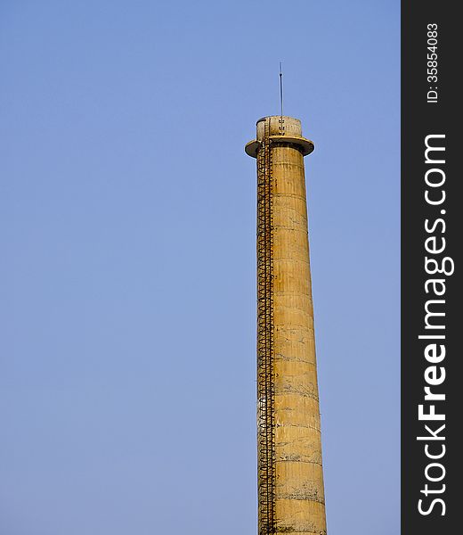 High old brick smokestack in sunny day