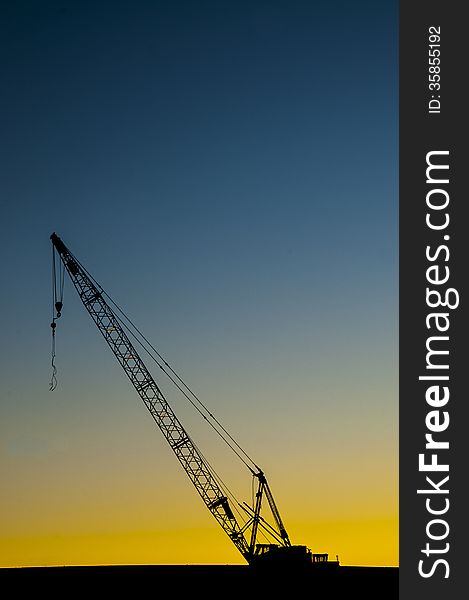 Semi-silhouette of construction crane in late afternoon.