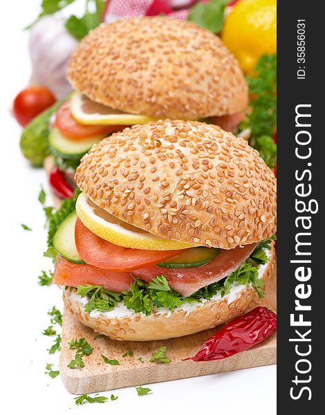 Burger with smoked salmon and vegetables, isolated