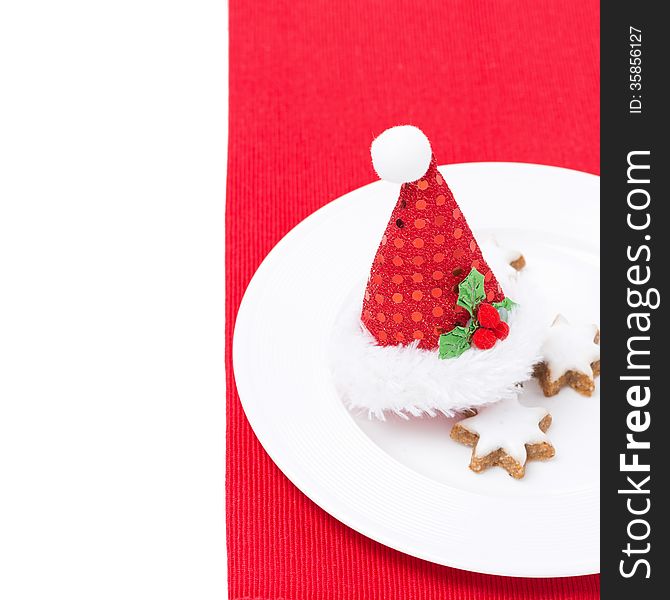 Christmas table setting with red cap and cookies, isolated