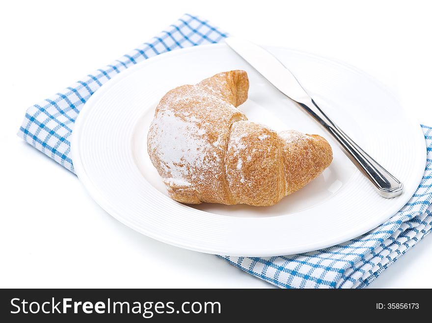 Croissant and a knife, isolated on white
