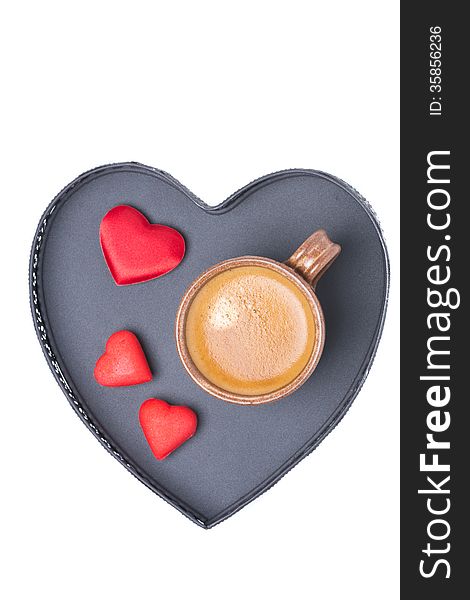 Cup of coffee and candy on a tray in the form of heart, isolated
