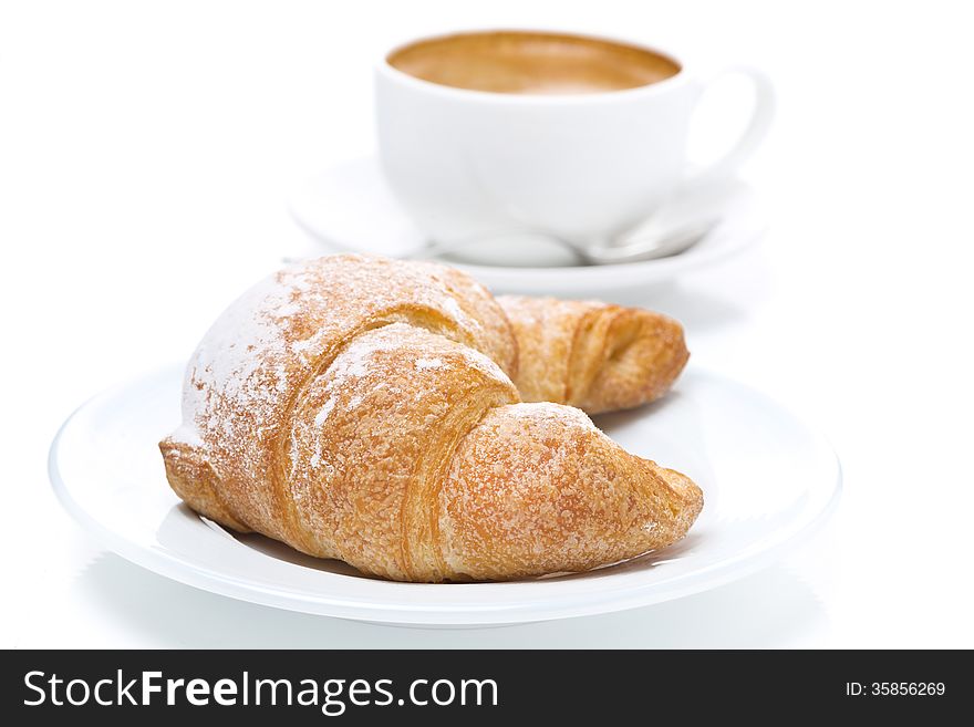 Delicious croissant and cup of black coffee, close-up, isolated