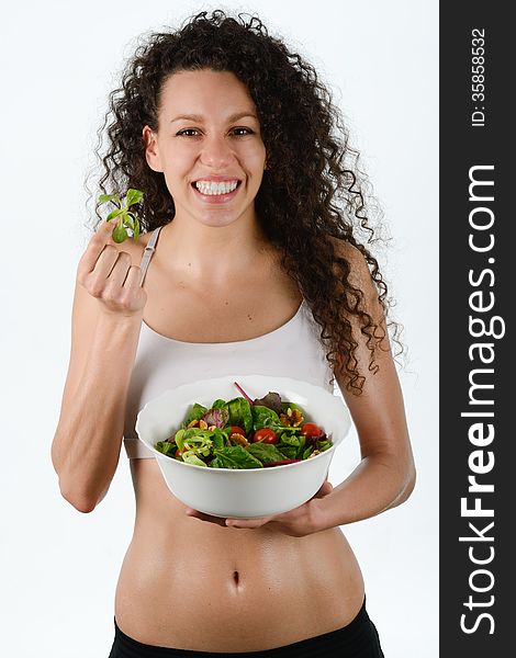 Portrait of beautiful young mixed woman with salad, isolated on white