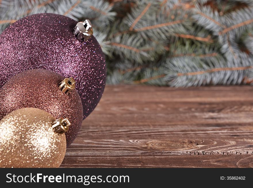 Christmas Balls And Pine Needles On Wooden Background