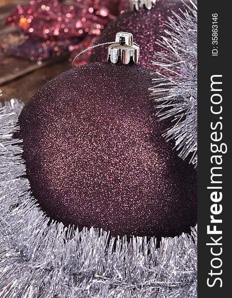 Christmas balls and tinsel on wooden background. Christmas balls and tinsel on wooden background