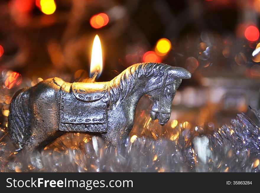 New Year`s candle in the form of a horse