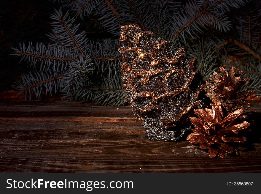 New Year`s composition of a pine cones on a wooden background