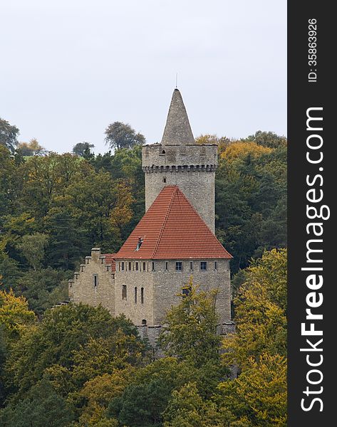 Castle with red roof in the middle of autumn forest. Castle with red roof in the middle of autumn forest