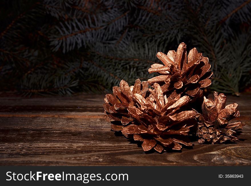 New Year`s composition of a pine cones on a wooden background