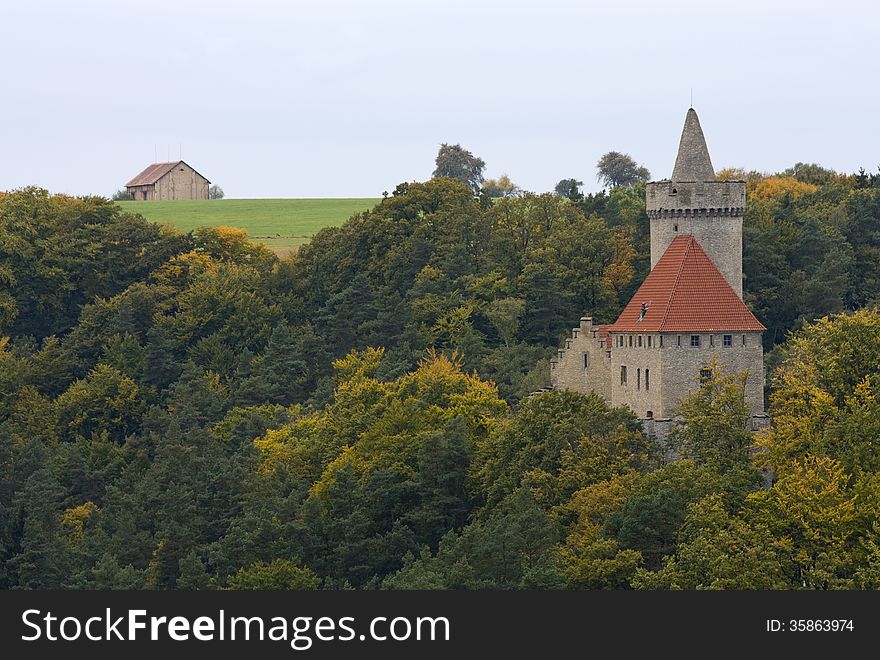 Castle in autumn forest and barn in the background on a meadow. Castle in autumn forest and barn in the background on a meadow