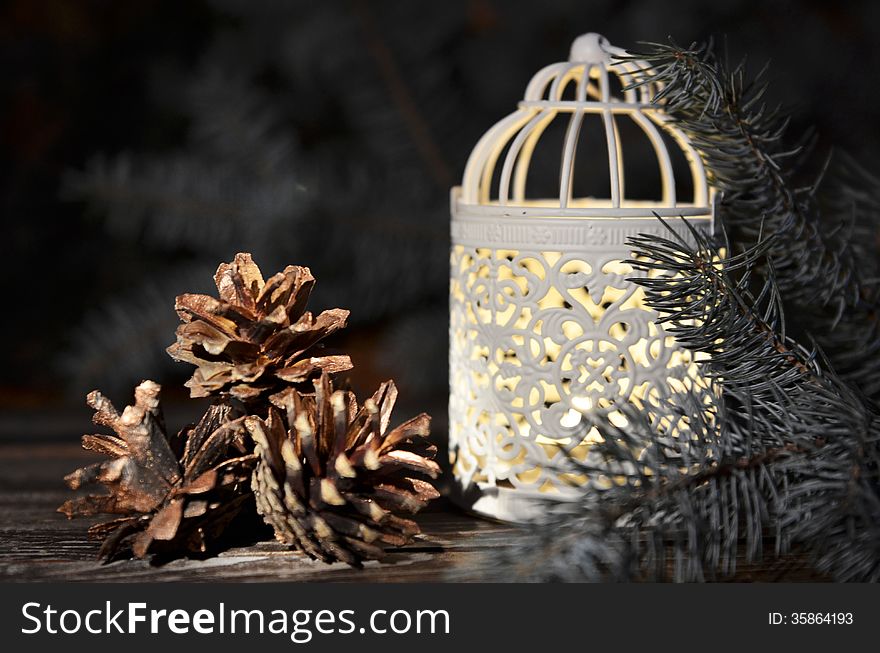 New Year`s composition of a pine cones and Vintage Christmas candlestick on a wooden background