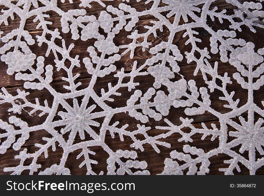 New Year`s composition of snowflakes on a wooden background. New Year`s composition of snowflakes on a wooden background