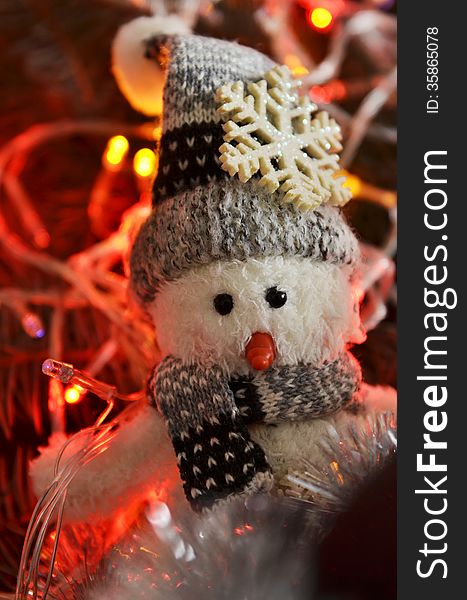 New Year`s composition of a snowman, tinsel and lights
