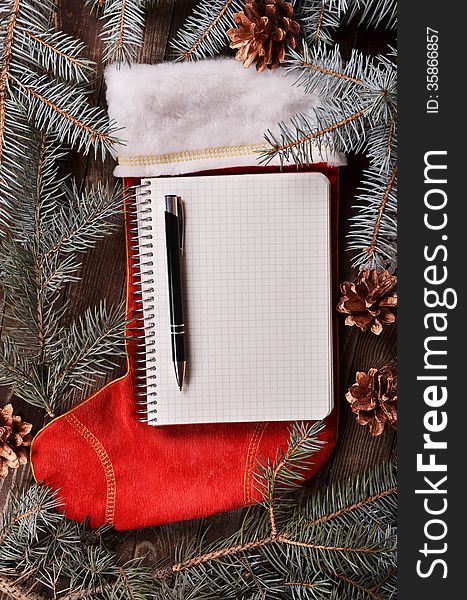 Composition of a red Christmas sock and fir branches