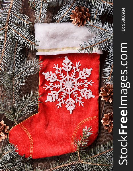 New Year`s composition of a red Christmas sock and snowflakes. New Year`s composition of a red Christmas sock and snowflakes