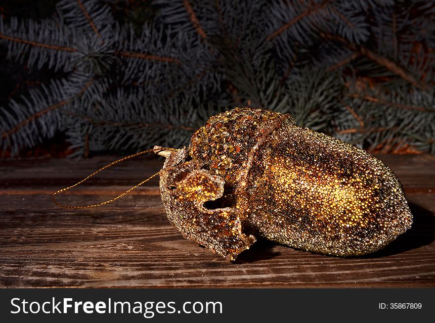 Christmas golden acorn and spruce twigs on a wooden background