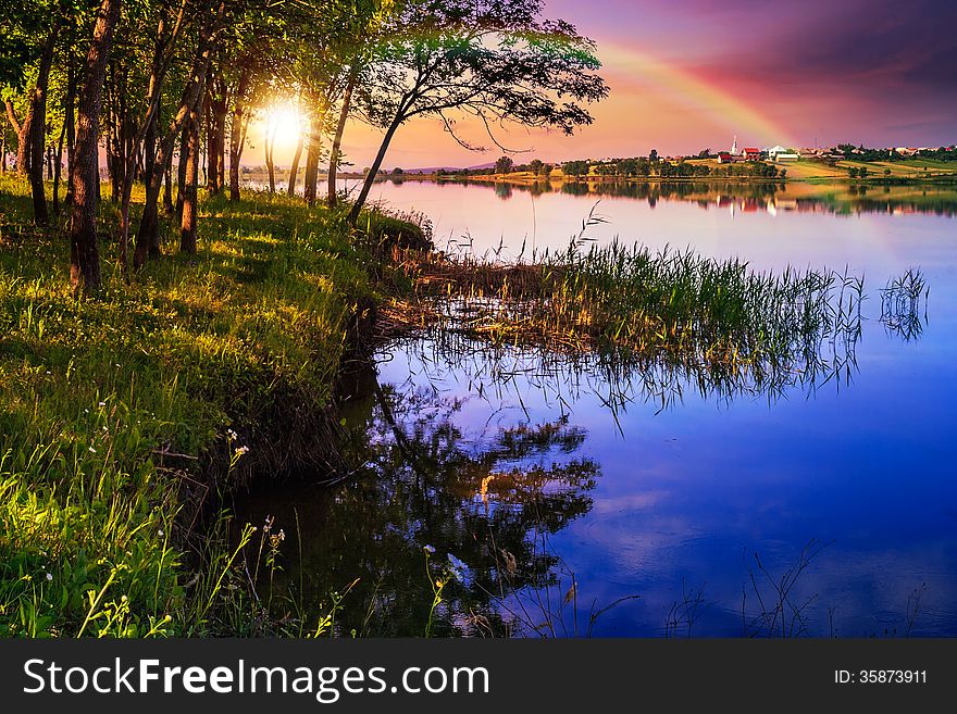 Mountain lake and forest on the embankment in evening. Mountain lake and forest on the embankment in evening