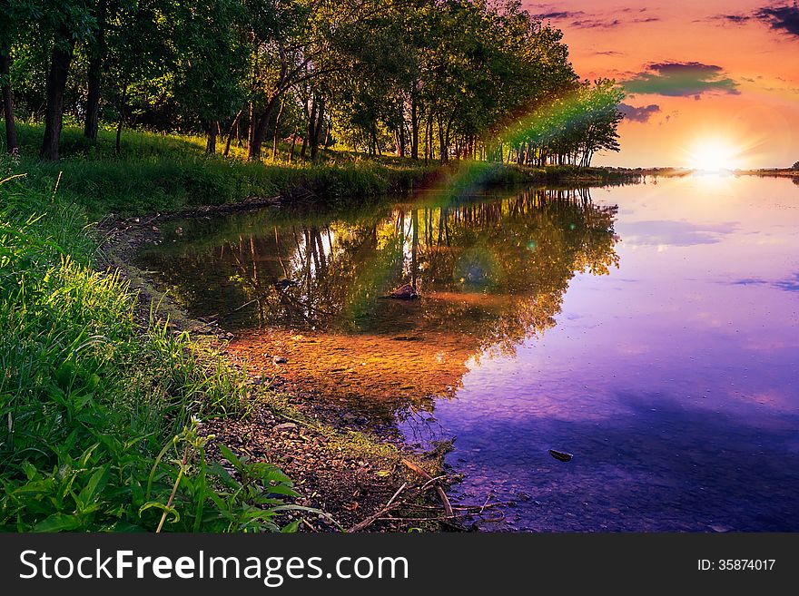 Mountain lake and forest on the embankment in evening. Mountain lake and forest on the embankment in evening