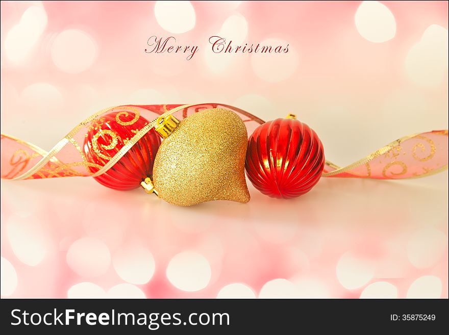 Merry Christmas card, with christmas decorations, ribbon, soft background lights and text. Room for more text.