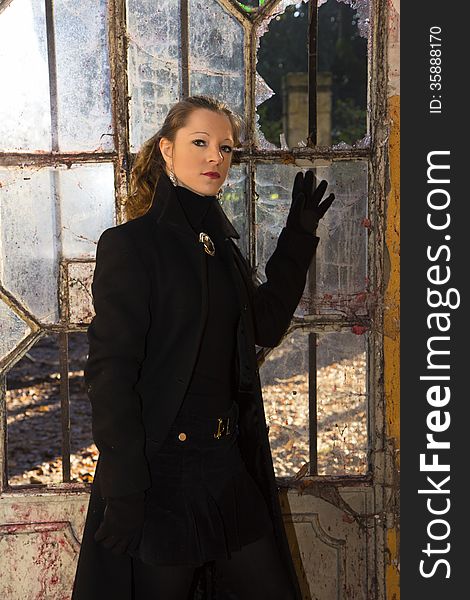 Model posing in long coat in abandoned place. Model posing in long coat in abandoned place