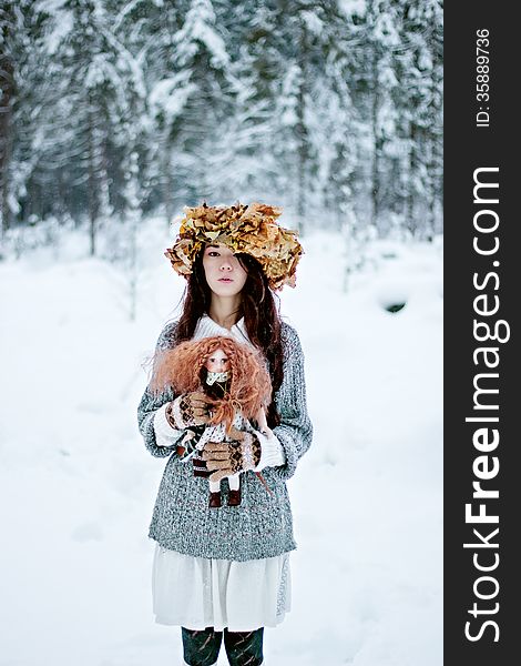 Forest Woman With Autumn Leaves And Little Doll In White Snow Winter