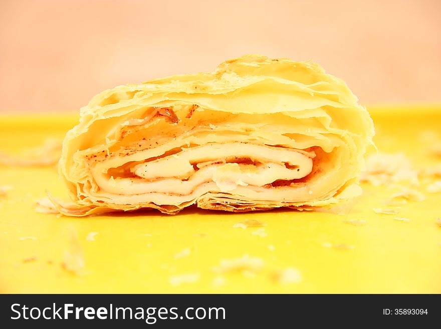 Sliced â€‹â€‹apple strudel on a yellow platter