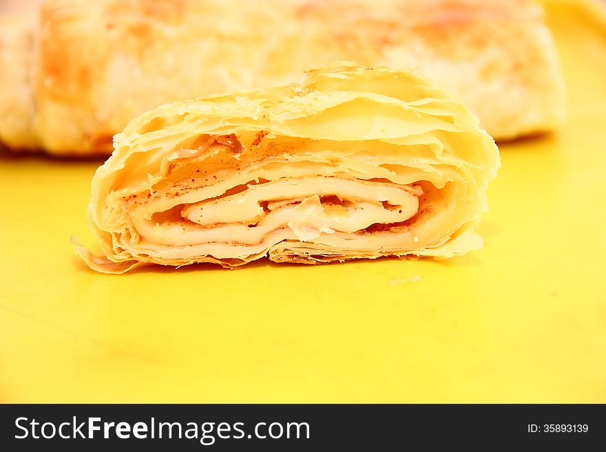 Sliced ​​apple strudel on a yellow platter