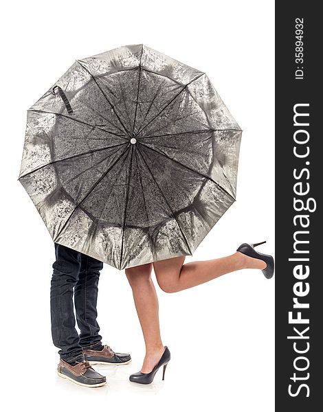 Female and man's legs under a umbrella. Female and man's legs under a umbrella