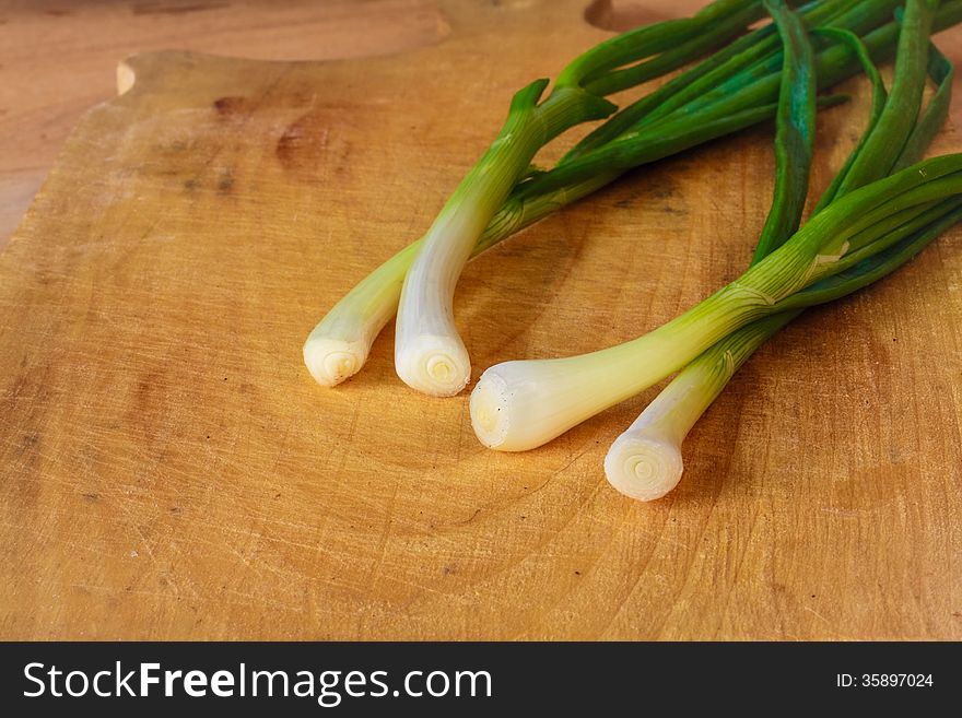 Spring Green Onions Group On Wooden Desk