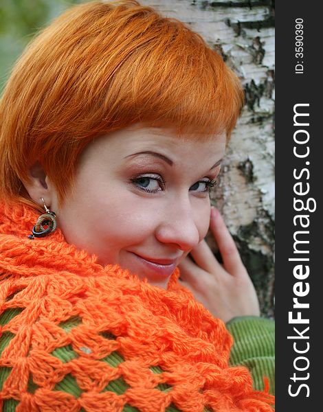 Young red-haired woman in red scarf. Young red-haired woman in red scarf