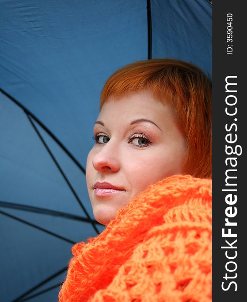 Young red-haired woman with umbrella