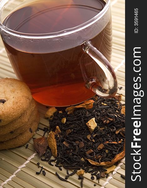 Glass tea, dried tea leaves and cookies. Glass tea, dried tea leaves and cookies