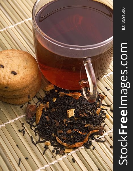 Glass tea, dried tea leaves and cookies. Glass tea, dried tea leaves and cookies