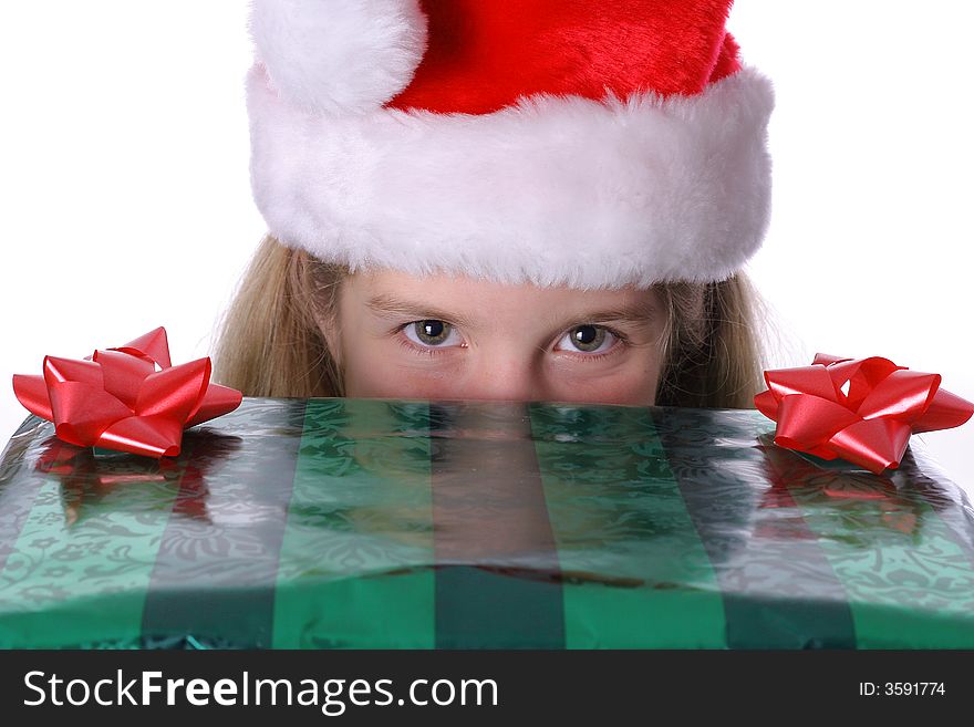 Shot of a child peeking over a present