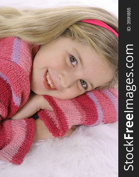 Shot of a gorgeous child in a pink sweater