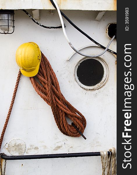 Yellow helmet and cables on a white wall