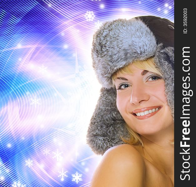 Beautiful young girl in winter fur-cap