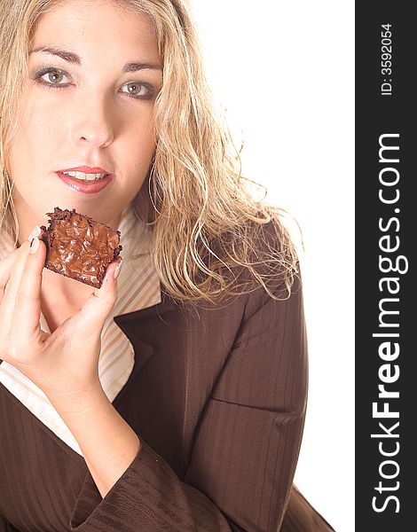 Shot of a gorgeous woman eating a brownie