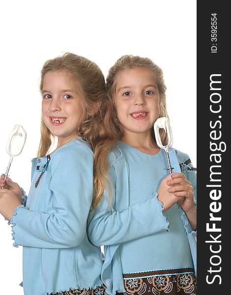 Shot of twin girls baking vertical upclose